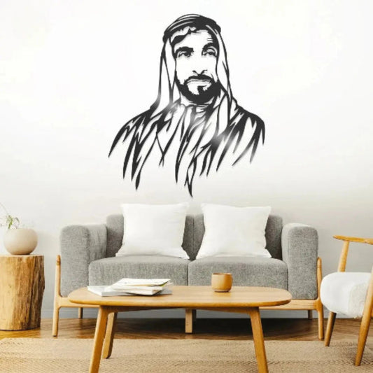 Living room with a gray sofa, wooden coffee table, and wall decal of a bearded man.
