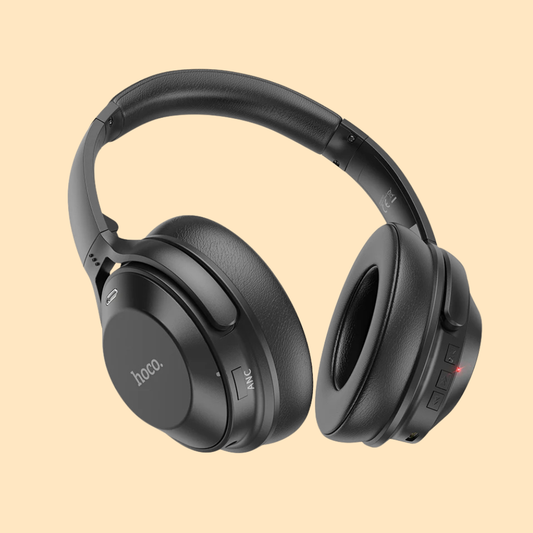 Black over-ear headphones on a beige background